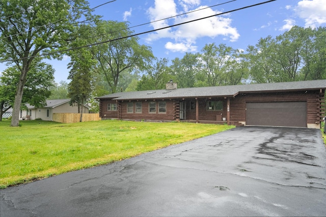 189 E 34th St, Steger, IL 60475 - log-style house with log siding, a chimney, a garage, and asphalt driveway