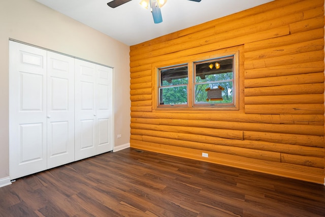 189 E 34th St, Steger, IL 60475 - unfurnished bedroom featuring dark wood-style flooring, log walls, a closet, and a ceiling fan
