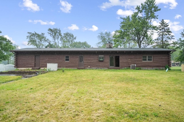 189 E 34th St, Steger, IL 60475 - rear view of house featuring log exterior, a lawn, and a chimney