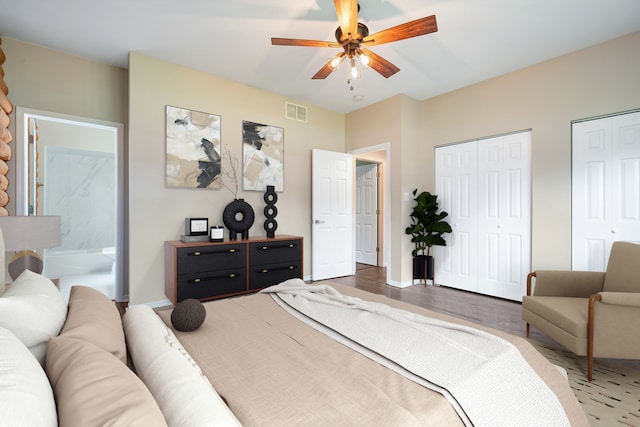 189 E 34th St, Steger, IL 60475 - bedroom featuring two closets, wood finished floors, connected bathroom, and ceiling fan