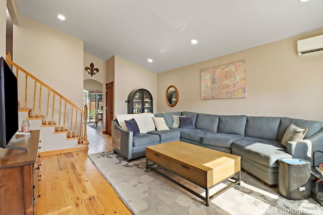 6312 Londonderry Dr, Cary, IL 60013 - living area featuring an AC wall unit, light wood-style floors, stairs, lofted ceiling, and recessed lighting