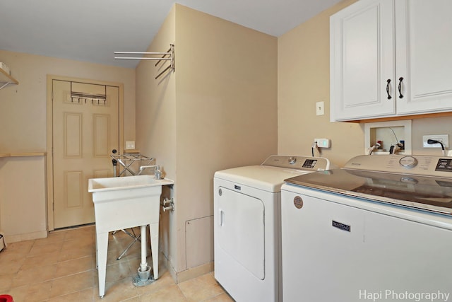 6312 Londonderry Dr, Cary, IL 60013 - laundry room featuring cabinet space, washer and clothes dryer, and light tile patterned floors