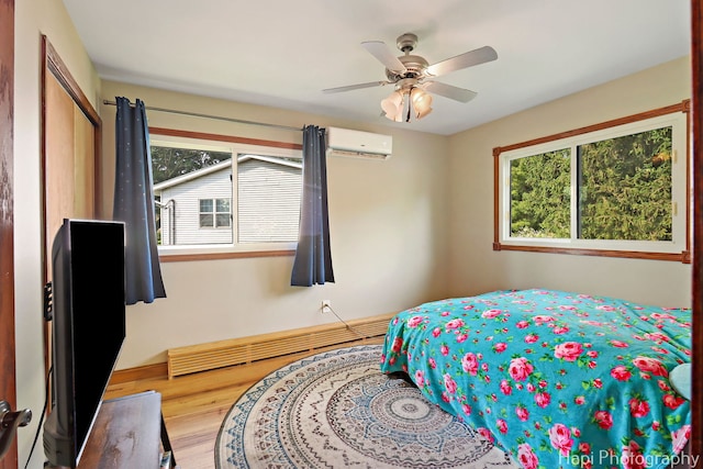 6312 Londonderry Dr, Cary, IL 60013 - bedroom with a wall mounted AC, wood finished floors, ceiling fan, and a closet