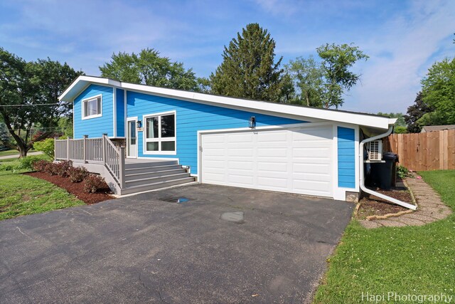 6312 Londonderry Dr, Cary, IL 60013 - view of front of house featuring a garage and asphalt driveway