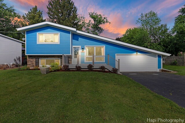 6312 Londonderry Dr, Cary, IL 60013 - split level home featuring a yard, a garage, driveway, and brick siding