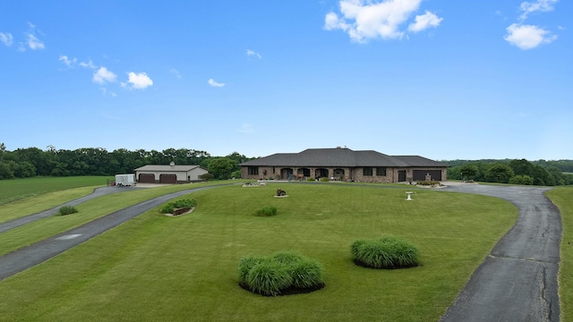 2765 W Pines Rd, Oregon, IL 61061 - ranch-style house with asphalt driveway, an attached garage, and a front yard