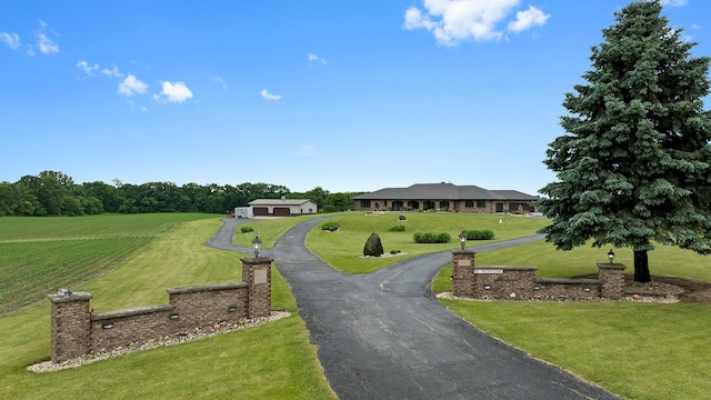 2765 W Pines Rd, Oregon, IL 61061 - view of community featuring a yard and curved driveway