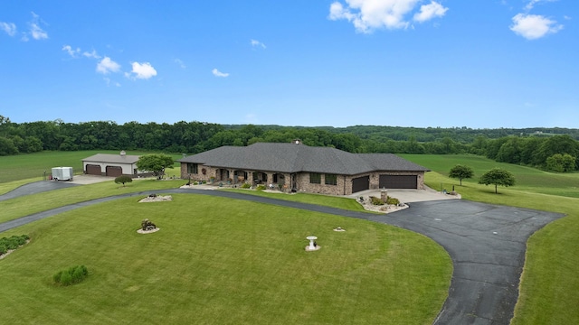2765 W Pines Rd, Oregon, IL 61061 - view of front facade featuring a front yard, a garage, and asphalt driveway