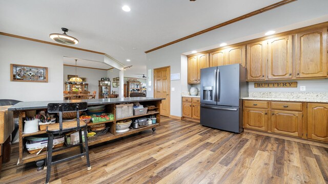 2765 W Pines Rd, Oregon, IL 61061 - kitchen featuring stainless steel refrigerator with ice dispenser, ornamental molding, light wood finished floors, recessed lighting, and light stone countertops
