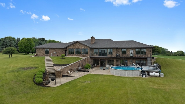 2765 W Pines Rd, Oregon, IL 61061 - back of property with a patio area, a lawn, an outdoor pool, brick siding, and a chimney