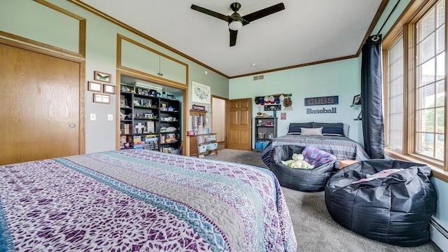 2765 W Pines Rd, Oregon, IL 61061 - bedroom with carpet floors, ornamental molding, a baseboard heating unit, and a ceiling fan