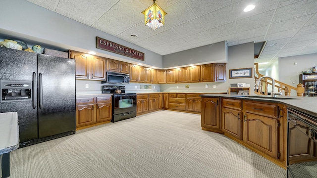 2765 W Pines Rd, Oregon, IL 61061 - kitchen featuring black appliances, light carpet, brown cabinetry, a sink, and a paneled ceiling