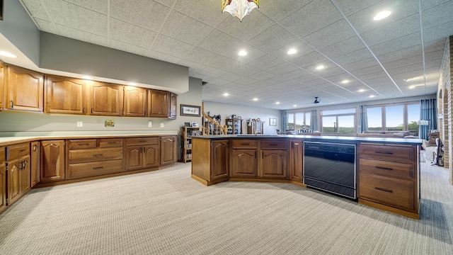 2765 W Pines Rd, Oregon, IL 61061 - kitchen with black dishwasher, light colored carpet, recessed lighting, brown cabinetry, and a sink