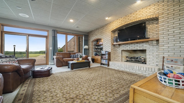 2765 W Pines Rd, Oregon, IL 61061 - living area with brick wall, carpet, a baseboard heating unit, a fireplace, and recessed lighting