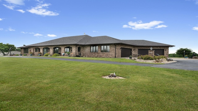 2765 W Pines Rd, Oregon, IL 61061 - view of front of house with a garage, a front yard, brick siding, driveway, and roof with shingles
