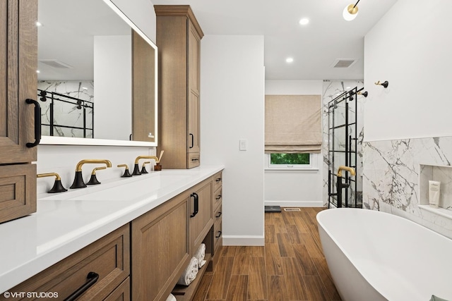 25801 Twin Pond Rd, Lake Barrington, IL 60010 - bathroom with a soaking tub, vanity, wood finished floors, and recessed lighting