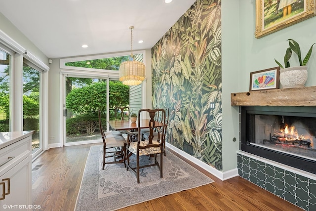 25801 Twin Pond Rd, Lake Barrington, IL 60010 - dining area featuring wood finished floors, a warm lit fireplace, a chandelier, recessed lighting, and an accent wall