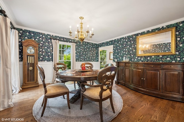 25801 Twin Pond Rd, Lake Barrington, IL 60010 - dining area featuring a chandelier, wainscoting, wallpapered walls, wood finished floors, and crown molding