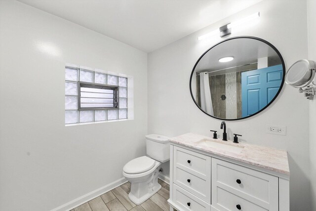 4322 Amelia Ave, Lyons, IL 60534 - full bath featuring vanity, toilet, baseboards, wood finished floors, and curtained shower