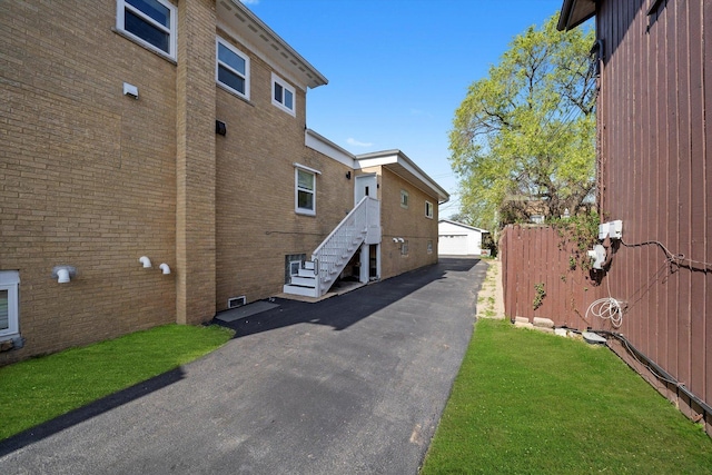 4322 Amelia Ave, Lyons, IL 60534 - view of home's exterior featuring brick siding, an outdoor structure, and a garage