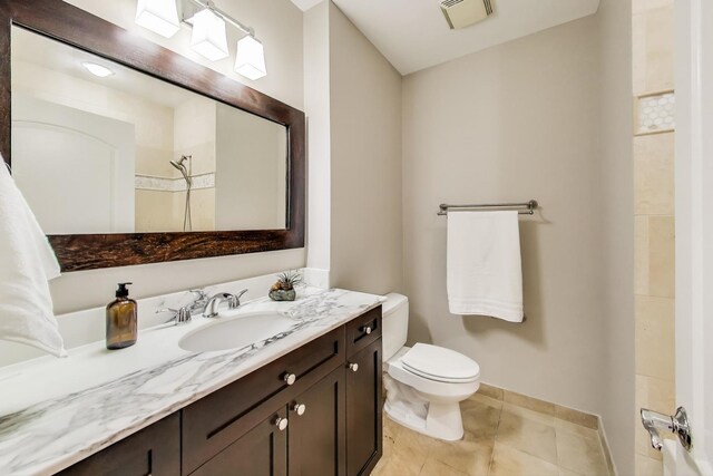 101 W Superior St Unit 501, Chicago, IL 60654 - bathroom featuring vanity, toilet, tile patterned flooring, baseboards, and a shower