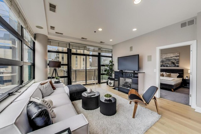 101 W Superior St Unit 501, Chicago, IL 60654 - living room featuring wood finished floors, recessed lighting, and a fireplace