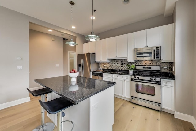 101 W Superior St Unit 501, Chicago, IL 60654 - kitchen with appliances with stainless steel finishes, light wood finished floors, a sink, backsplash, and recessed lighting