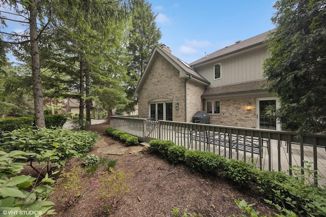 6 Tartan Ridge Rd, Burr Ridge, IL 60527 - rear view of property with brick siding, a chimney, a wooden deck, and a shingled roof