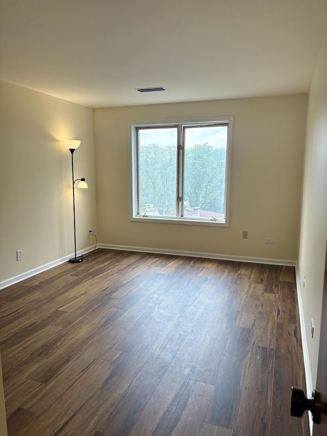 5501 Lincoln Ave Unit 405, Morton Grove, IL 60053 - spare room with dark wood-style floors and baseboards