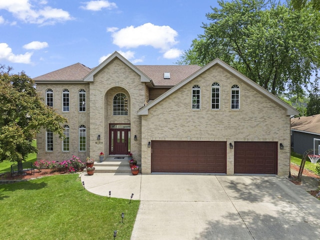 5N311 Lloyd Ave, Itasca, IL 60143 - view of front of home with a garage, a front yard, driveway, and brick siding