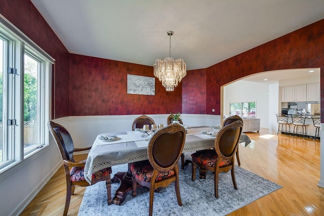 5N311 Lloyd Ave, Itasca, IL 60143 - dining room featuring arched walkways, light wood-style flooring, and a chandelier