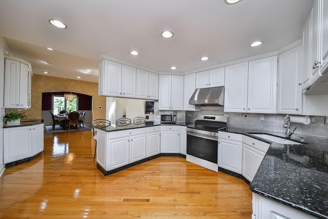 5N311 Lloyd Ave, Itasca, IL 60143 - kitchen featuring appliances with stainless steel finishes, under cabinet range hood, a peninsula, white cabinetry, and a chandelier
