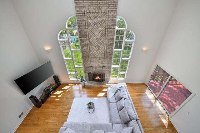 5N311 Lloyd Ave, Itasca, IL 60143 - living area featuring a high ceiling, a brick fireplace, and wood finished floors