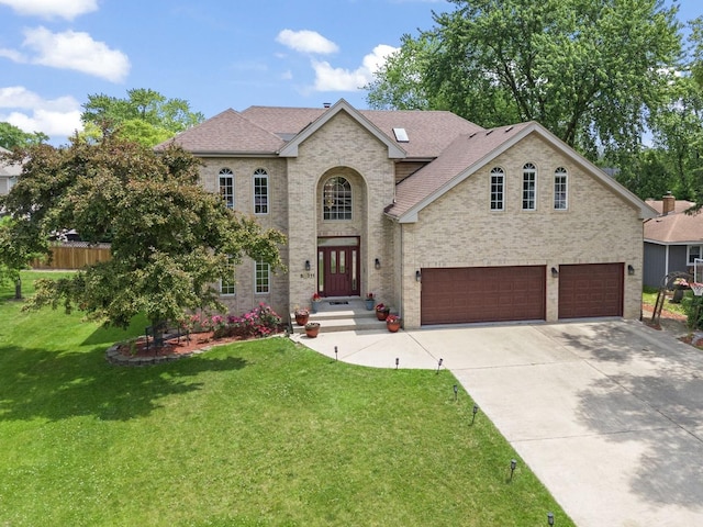 5N311 Lloyd Ave, Itasca, IL 60143 - french country inspired facade featuring an attached garage, concrete driveway, and a shingled roof