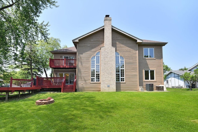 5N311 Lloyd Ave, Itasca, IL 60143 - rear view of house with a fire pit, a chimney, a lawn, and a deck