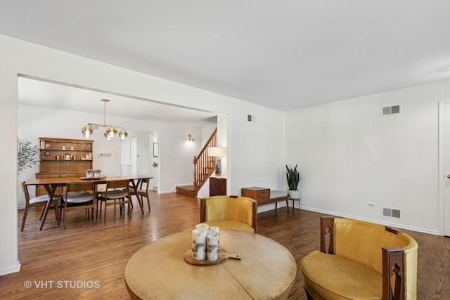 567 Byrd Rd, Riverside, IL 60546 - living room featuring stairway, wood finished floors, and a chandelier