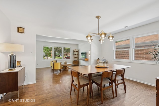 567 Byrd Rd, Riverside, IL 60546 - dining area featuring wood finished floors and a chandelier