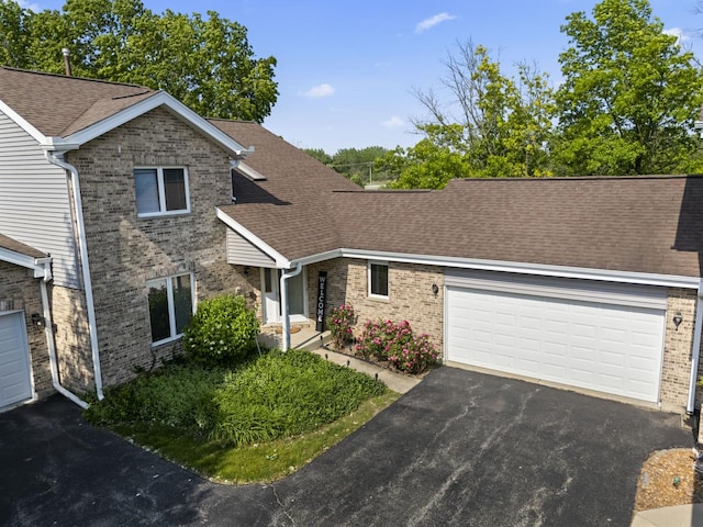 11234 Lakefield Dr, Orland Park, IL 60467 - view of front of property with brick siding, driveway, a garage, and a shingled roof