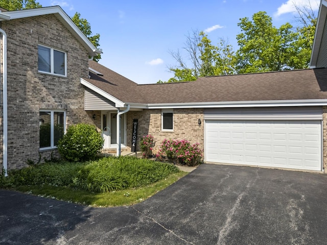 11234 Lakefield Dr, Orland Park, IL 60467 - view of front of property with brick siding, driveway, an attached garage, and roof with shingles