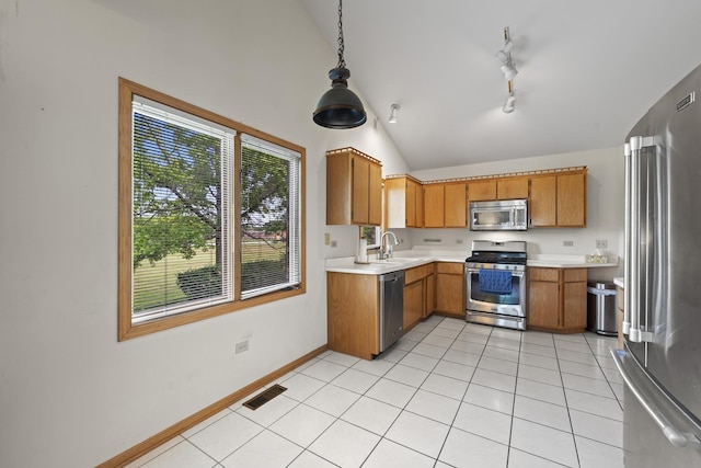 11234 Lakefield Dr, Orland Park, IL 60467 - kitchen featuring stainless steel appliances, light countertops, brown cabinets, a sink, and vaulted ceiling