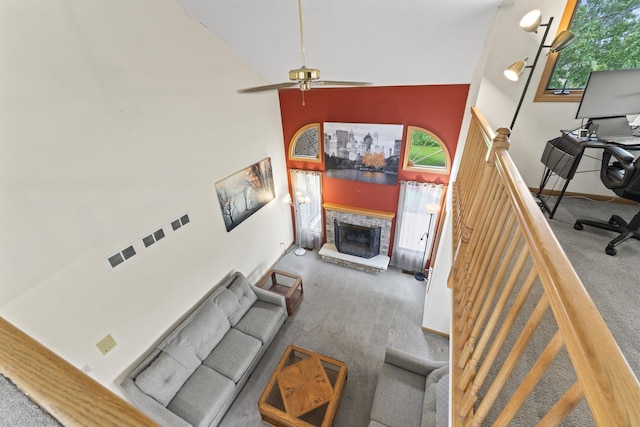 11234 Lakefield Dr, Orland Park, IL 60467 - living area with carpet flooring, a towering ceiling, ceiling fan, a fireplace with raised hearth, and a desk