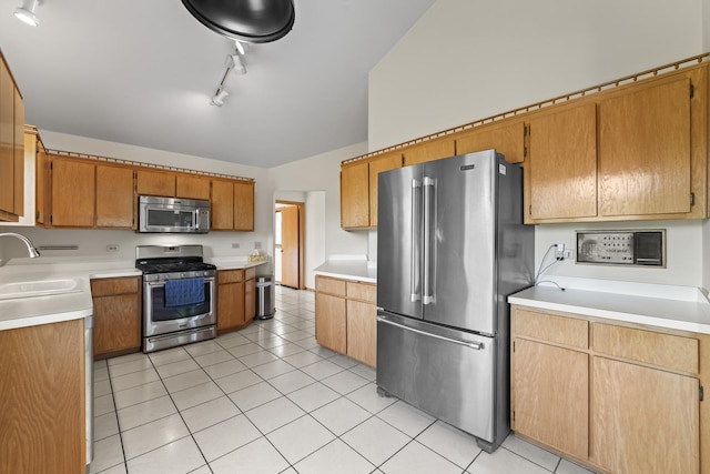 11234 Lakefield Dr, Orland Park, IL 60467 - kitchen featuring appliances with stainless steel finishes, a sink, light countertops, light tile patterned floors, and track lighting