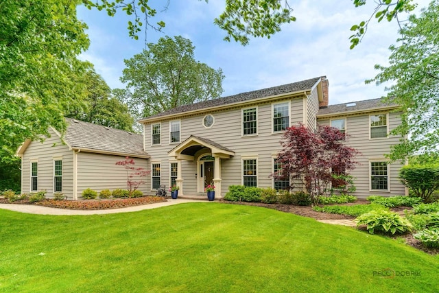 1602 Wickham Ct, Libertyville, IL 60048 - colonial house with a front lawn and a chimney