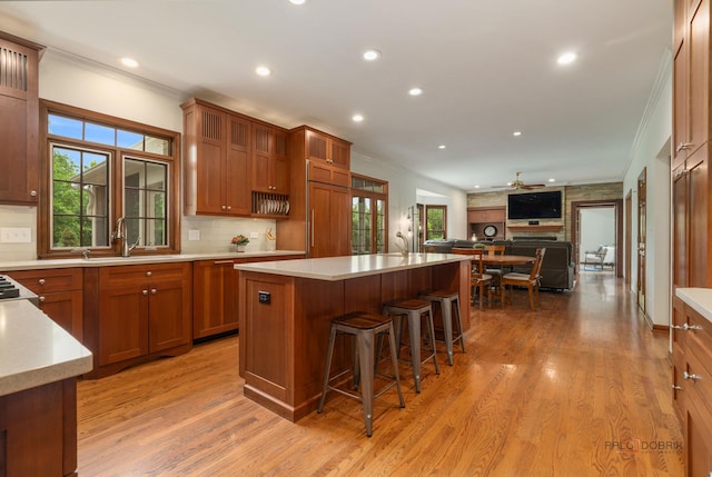 1602 Wickham Ct, Libertyville, IL 60048 - kitchen with crown molding, light countertops, light wood finished floors, brown cabinets, and recessed lighting