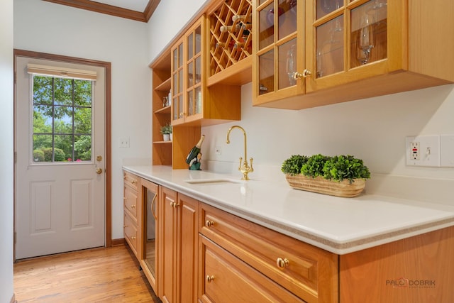1602 Wickham Ct, Libertyville, IL 60048 - kitchen with light wood-type flooring, crown molding, light countertops, glass insert cabinets, and brown cabinets
