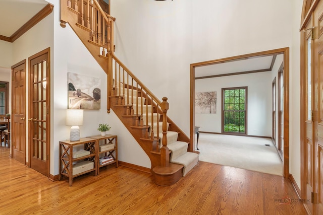 1602 Wickham Ct, Libertyville, IL 60048 - stairway with wood finished floors, a high ceiling, crown molding, and french doors