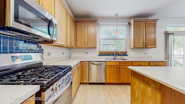 6542 Pine Hollow Rd, Carpentersville, IL 60110 - kitchen featuring stainless steel appliances, light countertops, pendant lighting, and light wood-style floors