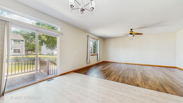 6542 Pine Hollow Rd, Carpentersville, IL 60110 - unfurnished room featuring wood finished floors, ceiling fan, and a chandelier