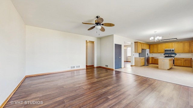 6542 Pine Hollow Rd, Carpentersville, IL 60110 - kitchen with appliances with stainless steel finishes, open floor plan, a chandelier, light countertops, and a ceiling fan