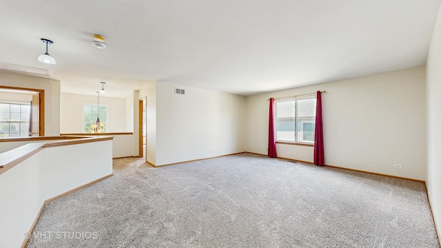 6542 Pine Hollow Rd, Carpentersville, IL 60110 - unfurnished room featuring light carpet and plenty of natural light